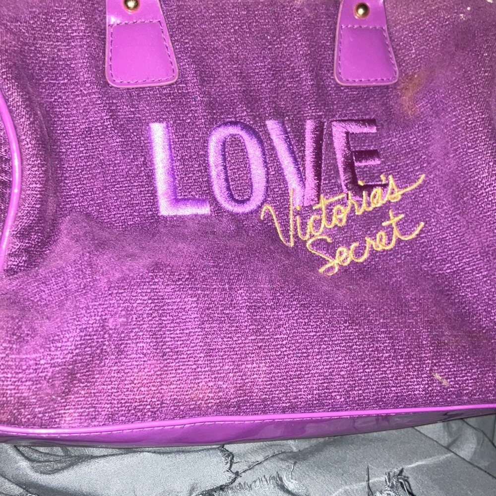 A dark purple, Victoria’s Secret bag